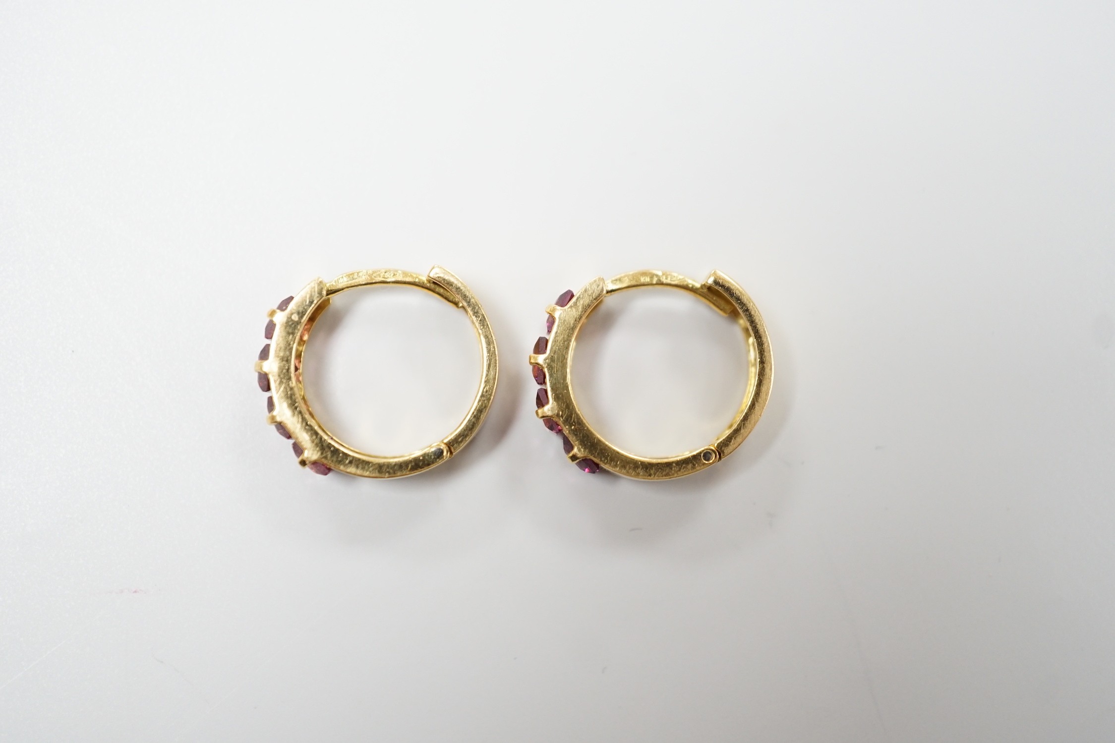 A modern pair of Italian 750 yellow metal and four stone square cut garnet set hoop earrings, 14mm, gross weight 4.2 grams.